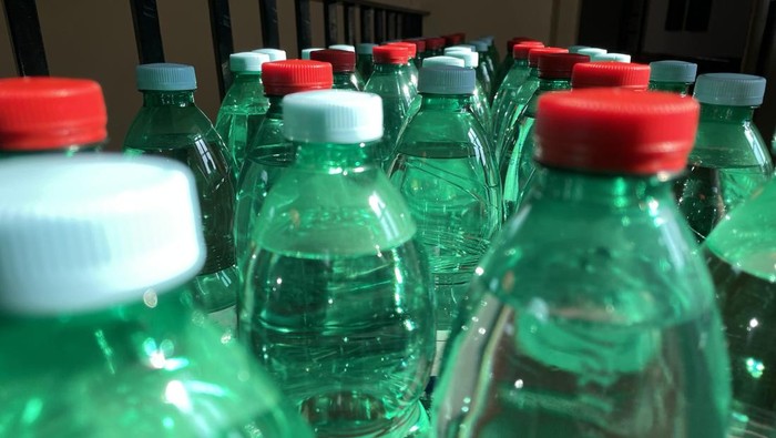 water bottle with colored caps arranged in a row