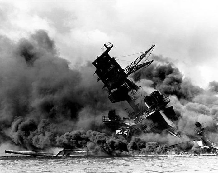 Vintage World War II photo of the USS Arizona burning after the Japanese attack on Pearl Harbor, December 7, 1941.