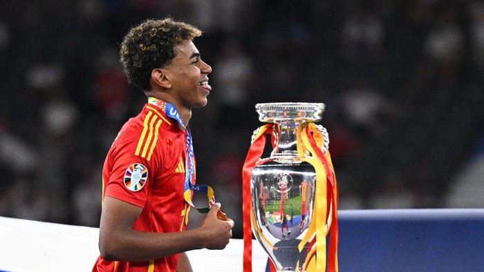15 July 2024, Berlin: Soccer, UEFA Euro 2024, European Championship, Final, Spain - England, Olympiastadion Berlin, Spains Lamine Yamal walks past the trophy with his gold medal after winning the final. Photo: Tom Weller/dpa (Photo by Tom Weller/picture alliance via Getty Images)
