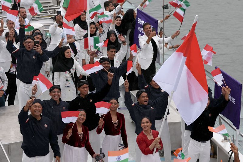 PARIS, FRANCE - JULY 26: Athletes of Team Indonesia are seen on a boat on the River Seine during the opening ceremony of the Olympic Games Paris 2024 on July 26, 2024 in Paris, France. (Photo by Lars Baron/Getty Images)