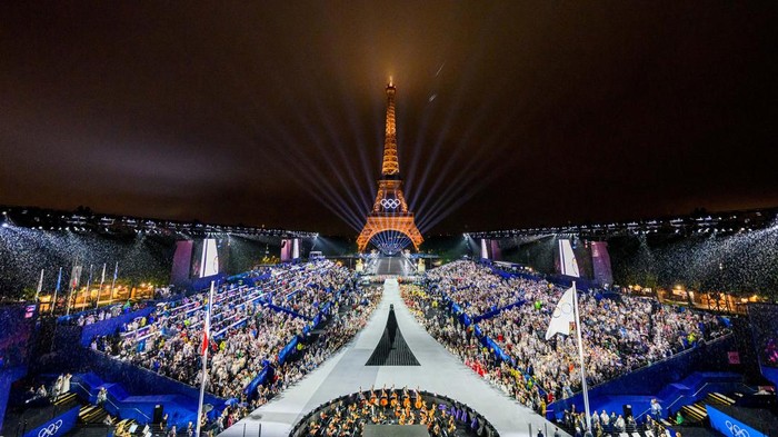 Gemerlap Menara Eiffel Saat Pembukaan Olimpiade Paris 2024 Paris 2024 Olympics - Opening Ceremony - Paris, France - July 26, 2024. Overview of the Trocadero venue, with the Eiffel Tower looming in the background while the Olympic flag is being raised, during the opening ceremony of the Paris 2024 Olympic Games. FRANCOIS-XAVIER MARIT/Pool via REUTERS TPX IMAGES OF THE DAY