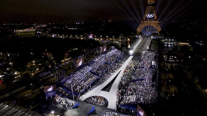 This photo released by the Olympic Broadcasting Services shows the Trocadero and the Eiffel Tower lightened up with the Olympic Rings during the opening ceremony for the 2024 Summer Olympics in Paris, France, Friday, July 26, 2024. (Olympic Broadcasting Services via AP)