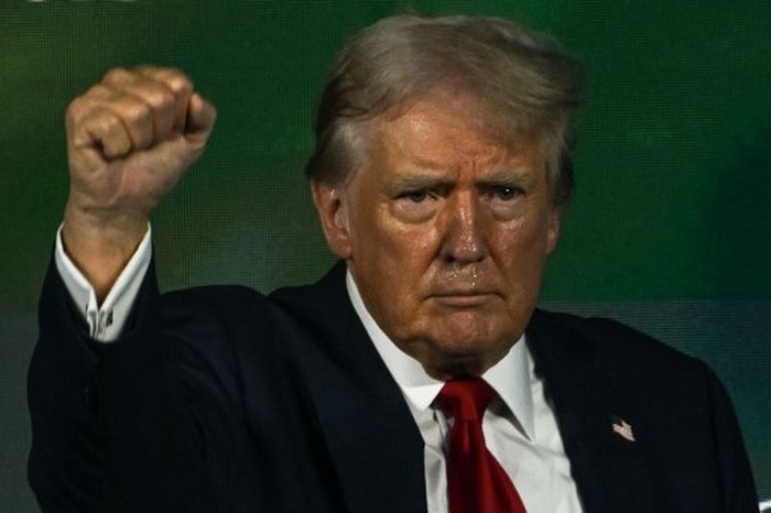 Former US President and 2024 Republican presidential candidate Donald Trump gestures after speaking at Turning Point Actions 