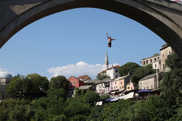 A high diver jumps from the arch of the Old Bridge during 458th edition of the traditional diving competition in Mostar, Bosnia and Herzegovina, July 28, 2024. REUTERS/Amel Emric