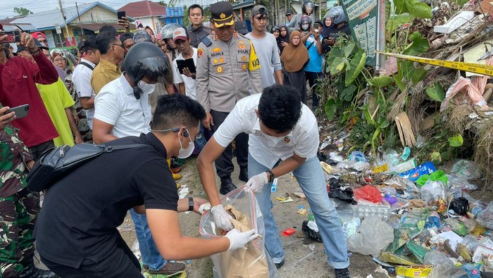 Polisi saat mengevakusi jasad bayi yang ditemukan di tempat sampah di Tanjabbar, Jambi