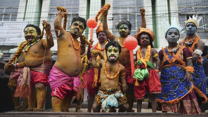 An artist dressed as Hindu goddess Mahakali performs during a procession marking 