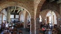 Wisatawan menikmati hidangan di kafe Benteng Van Den Bosch saat dibuka kembali pascarenovasi di Ngawi, Jawa Timur, Selasa (30/7/2024).    
