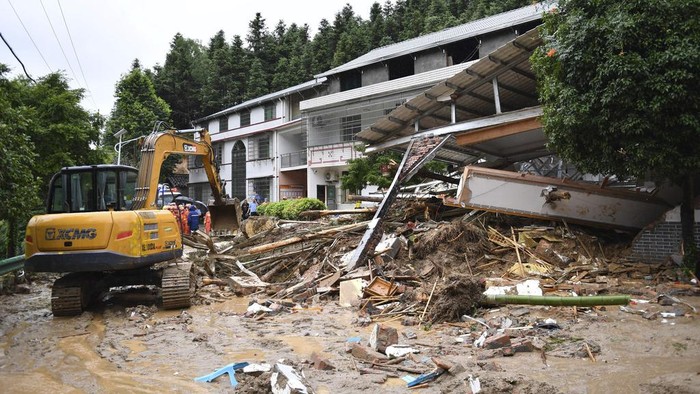 In this drone photo released by Xinhua News Agency, a landslide destroys a house in Yuelin village of Shouyue town of Hengyang city, central China's Hunan Province on Sunday, July 28, 2024. (Chen Zhenhai/Xinhua via AP)