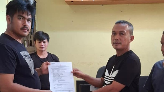 Proses penyerahan seorang WNA asal Malaysia (tengah) oleh warga ke polisi. (Dok Polres Karimun)