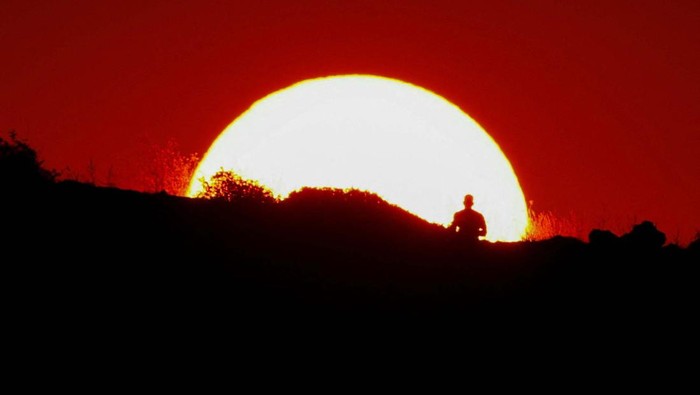 A person walks near Madliena Tower at sunset in Pembroke, Malta, July 30, 2024. REUTERS/Darrin Zammit Lupi