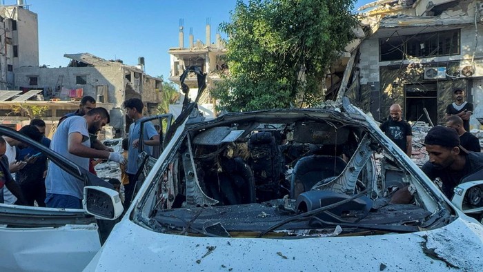 2 Jurnalis Al Jazeera Tewas Dibom Israel Palestinians inspect a vehicle where Al Jazeera TV said its reporter Ismail al-Ghoul and cameraman Ramy El Rify were killed in an Israeli strike, in Gaza City July 31, 2024. REUTERS/Ayman Al Hassi