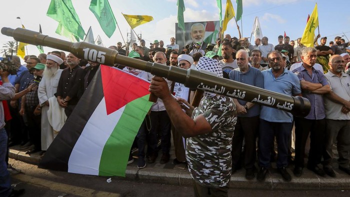Supporters of the Islamist Hamas movement hold posters of Hamas political chief Ismail Haniyeh during a protest to condemn his killing, at the Palestinian refugee camp of Ein el-Hilweh near the southern port city of Sidon, Lebanon, Wednesday, July 31, 2024. Haniyeh, Hamas' political chief in exile who landed on Israel's hit list after the militant group staged its surprise Oct. 7 attacks, was killed in an airstrike in the Iranian capital early Wednesday. (AP Photo/Mohammed Zaatari)