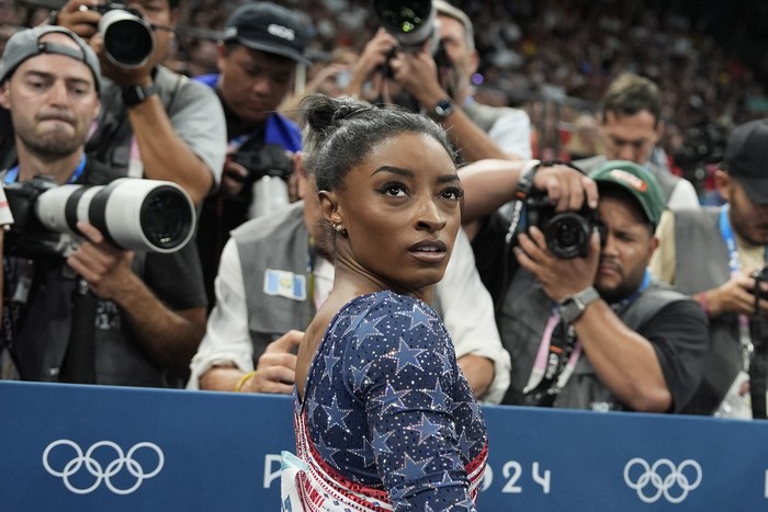Simone Biles, of the United States, waits to compete during the womens artistic gymnastics team finals round at Bercy Arena at the 2024 Summer Olympics, Tuesday, July 30, 2024, in Paris, France. (AP Photo/Charlie Riedel)