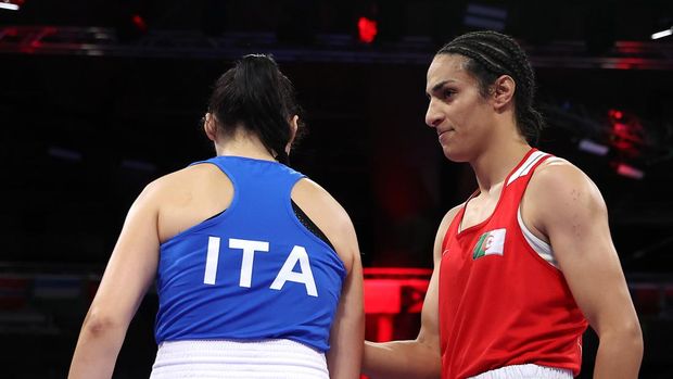PARIS, FRANCE - AUGUST 01: Imane Khelif of Team Algeria interacts with Angela Carini of Team Italy after she abandons the Women's 66kg preliminary round match in the first round on day six of the Olympic Games Paris 2024 at North Paris Arena on August 01, 2024 in Paris, France. (Photo by Richard Pelham/Getty Images)