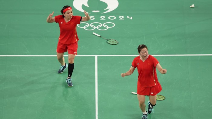 PARIS, FRANCE - AUGUST 02: Chen Qing Chen and Jia Yi Fan of Team Peoples Republic of China celebrate winning the Womens Doubles Semifinal match between Team Peoples Republic of China and Team Malaysia on day seven of the Olympic Games Paris 2024 at Porte de La Chapelle Arena on August 02, 2024 in Paris, France. (Photo by Julian Finney/Getty Images)