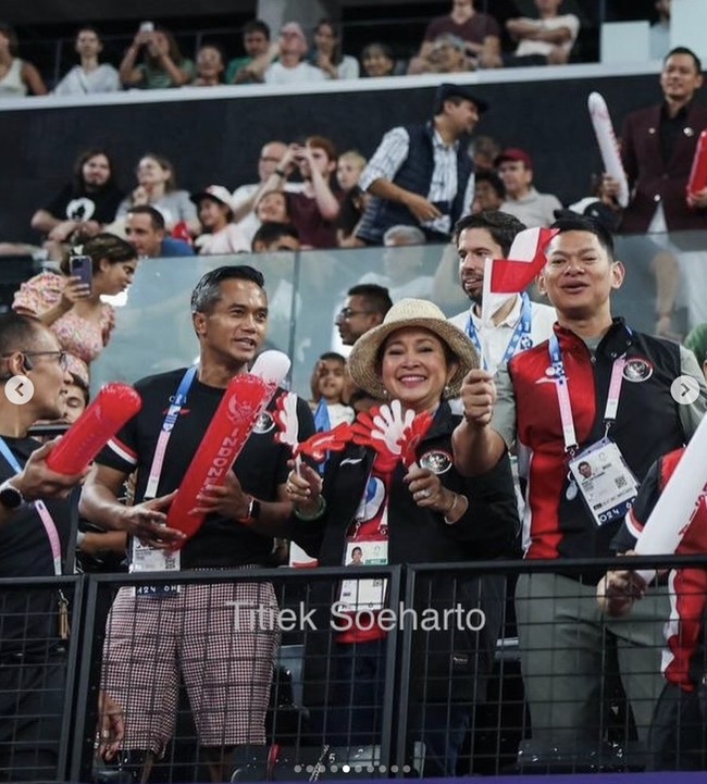 Titiek melengkapi gayanya dengan topi bergaya fedora yang dihiasi pita hitam. Dari bangku penonton, ia menyemangati Grogoria bersama Chef de Mission (CdM) kontingen Indonesia Anindya Bakrie dan Ketua Umum Komite Olimpiade Indonesia Raja Sapta Oktohari. (Foto: Instagram/@titieksoeharto)