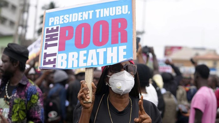 A woman protest against hardship on the street of Lagos, Nigeria, Thursday, Aug. 1, 2024. Thousands of mostly young people poured onto the streets across Nigeria on Thursday as they protested against the country's worst cost-of-living crisis in a generation. Security forces fired tear gas to disperse some of the protesters in the capital, Abuja. (AP Photo/Sunday Alamba)