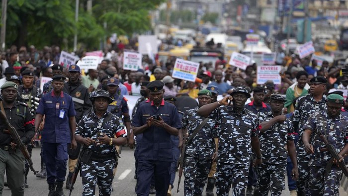 A woman protest against hardship on the street of Lagos, Nigeria, Thursday, Aug. 1, 2024. Thousands of mostly young people poured onto the streets across Nigeria on Thursday as they protested against the country's worst cost-of-living crisis in a generation. Security forces fired tear gas to disperse some of the protesters in the capital, Abuja. (AP Photo/Sunday Alamba)