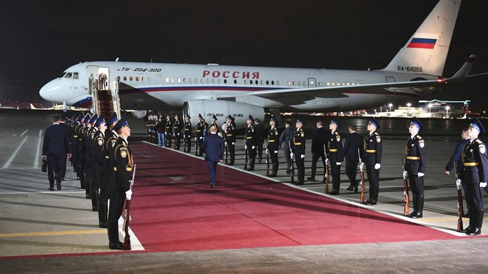 Russian President Vladimir Putin, center back to a camera, arrives to meet released Russian prisoners at the Vnukovo government airport outside Moscow, Russia, on Thursday, Aug. 1, 2024. The United States and Russia have made their biggest prisoner swap in post-Soviet history. (Sergei Ilyin, Sputnik, Kremlin Pool Photo via AP)