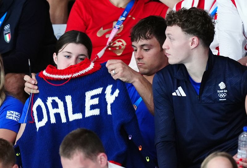 Great Britain's Tom Daley knitting as he watches the Women's Synchronised 3m Springboard Final at the Aquatics Centre on the first day of the 2024 Paris Olympic Games in France. Picture date: Saturday July 27, 2024. (Photo by Mike Egerton/PA Images via Getty Images)
