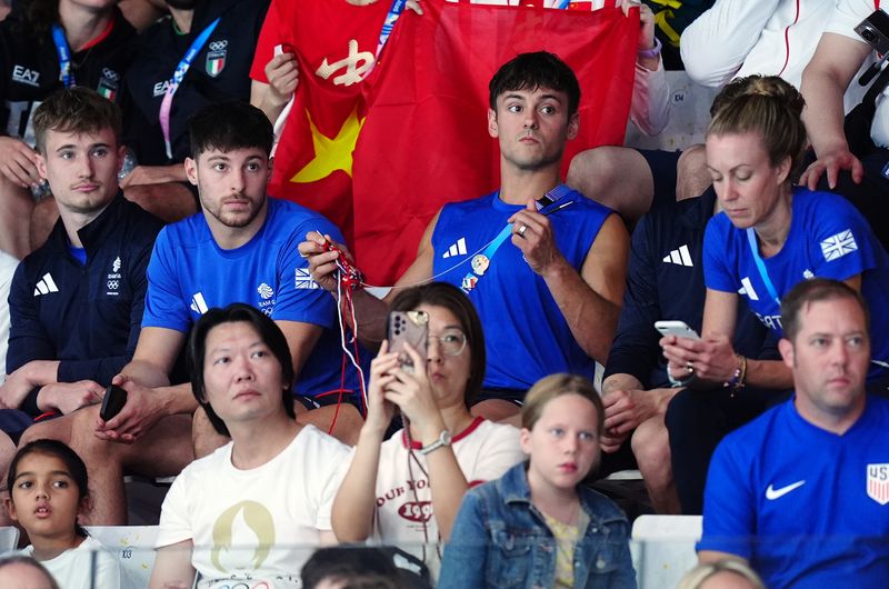 Great Britain's Tom Daley knitting as he watches the Women's Synchronised 3m Springboard Final at the Aquatics Centre on the first day of the 2024 Paris Olympic Games in France. Picture date: Saturday July 27, 2024. (Photo by Mike Egerton/PA Images via Getty Images)
