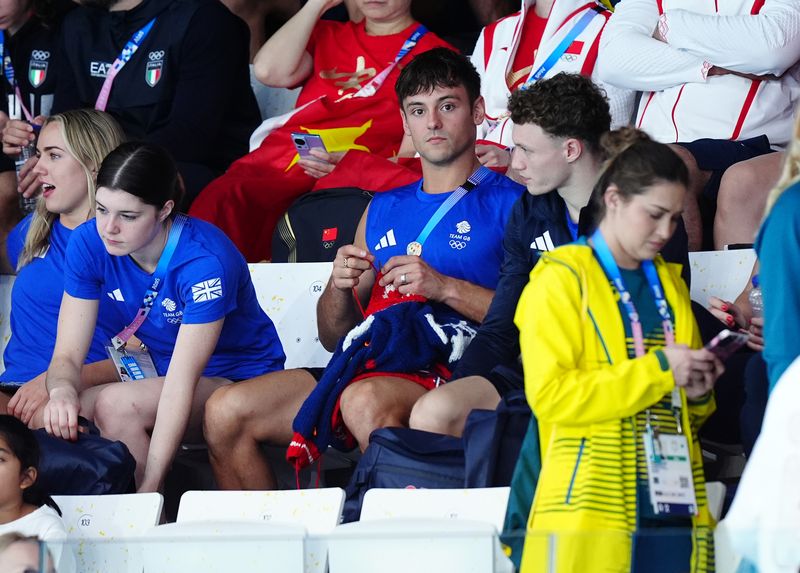 Great Britain's Tom Daley knitting as he watches the Women's Synchronised 3m Springboard Final at the Aquatics Centre on the first day of the 2024 Paris Olympic Games in France. Picture date: Saturday July 27, 2024. (Photo by Mike Egerton/PA Images via Getty Images)