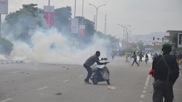 Police fired tear gas during a protest in Abuja, Nigeria, Thursday, Aug. 1, 2024. Thousands of mostly young people poured onto the streets across Nigeria on Thursday as they protested against the country's worst cost-of-living crisis in a generation. Security forces fired tear gas to disperse some of the protesters in the capital, Abuja. (AP Photo/Olamikan Gbemiga )