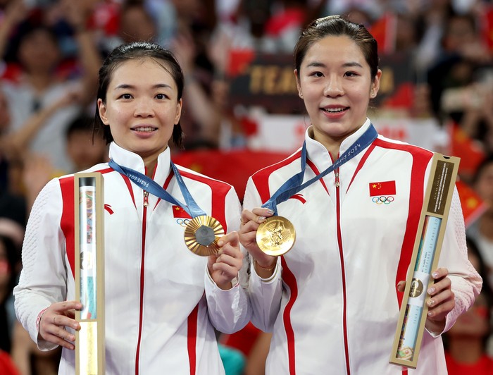 PARIS, FRANCE - AUGUST 03: Gold Medallists, Chen Qing Chen and Jia Yi Fan of Team People’s Republic of China pose for a photo on the top step of the podium after the Womens Doubles Gold Medal Match  on day eight of the Olympic Games Paris 2024 at Porte de La Chapelle Arena on August 03, 2024 in Paris, France. (Photo by Elsa/Getty Images)