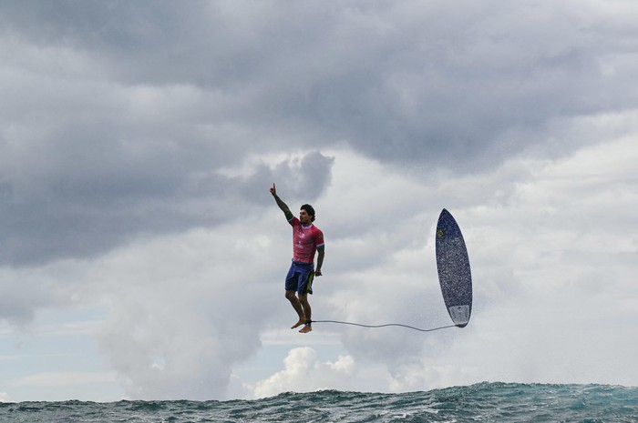 TOPSHOT - Brazils Gabriel Medina reacts after getting a large wave in the 5th heat of the mens surfing round 3, during the Paris 2024 Olympic Games, in Teahupoo, on the French Polynesian Island of Tahiti, on July 29, 2024. (Photo by Jerome BROUILLET / AFP) (Photo by JEROME BROUILLET/AFP via Getty Images)