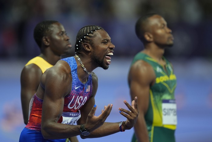Noah Lyles of the United States shouts as he prepares for the start of the mens 100-meter final at the 2024 Summer Olympics, Sunday, Aug. 4, 2024, in Saint-Denis, France. (AP Photo/Rebecca Blackwell)