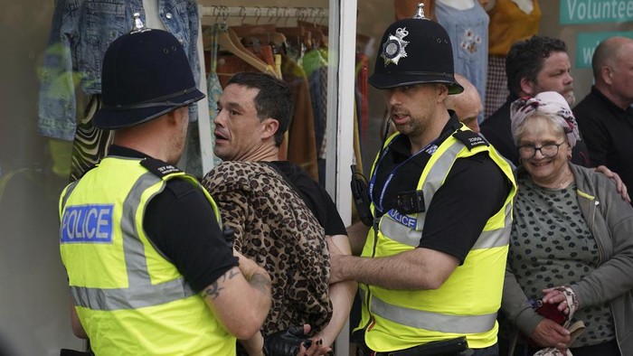 A man is detained by police officers during a protest in Nottingham, England Market Square on Saturday, Aug. 3, 2024, following Monday's stabbing attacks in Southport, in which three young children were killed. (Jacob King/PA via AP)