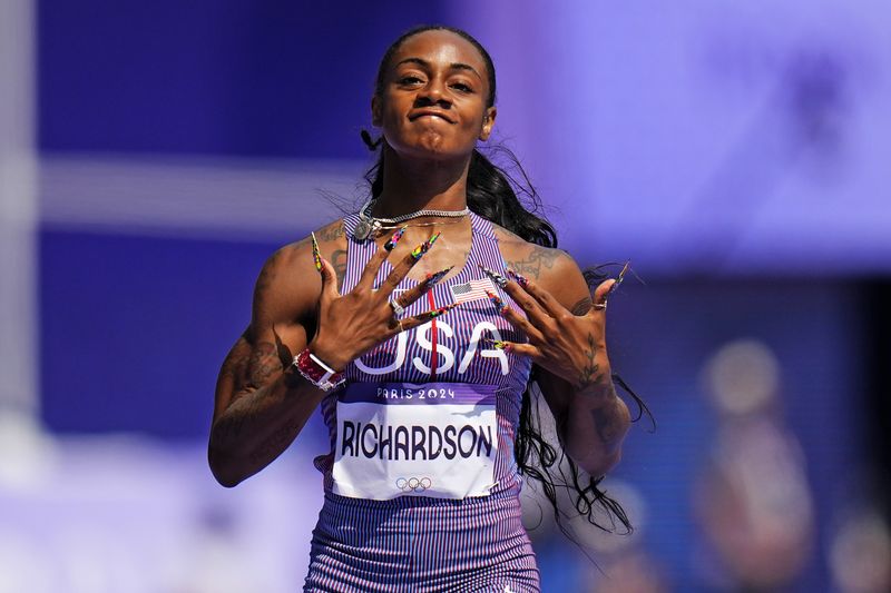 Sha'carri Richardson of the United States, wins a heat in the women's 100-meter run at the 2024 Summer Olympics, Friday, Aug. 2, 2024, in Saint-Denis, France. (AP Photo/Petr David Josek)
