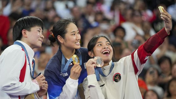 Pebulu tangkis tunggal putri Indonesia Gregoria Mariska Tunjung merayakan kemenangannya di podium setelah meraih medali perunggu di cabang bulu tangkis tunggal putri Olimpiade Musim Panas 2024, Senin, 5 Agustus 2024, di Paris, Prancis. (AP/Kin Cheung)