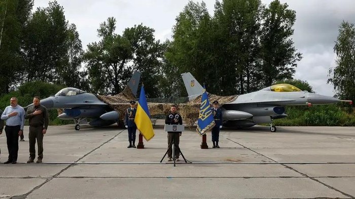 Ukraines President Volodymyr Zelenskiy signs a national anthem next to F-16 fighting aircrafts during marking the Day of the Ukrainian Air Forces, amid Russias attack on Ukraine, in an undisclosed location, Ukraine August 4, 2024. (Reuters)