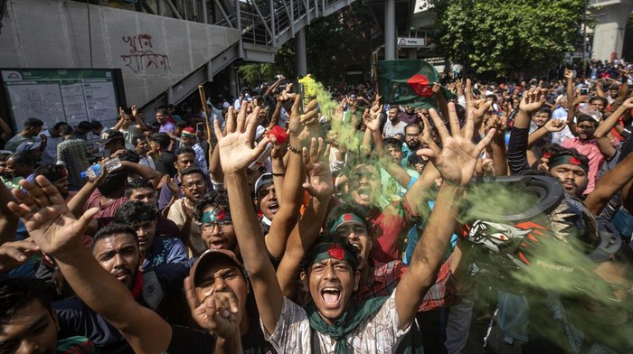 Protesters climb a public monument as they celebrate after getting the news of Prime Minister Sheikh Hasina's resignation, in Dhaka, Bangladesh, Monday, Aug. 5, 2024. (AP Photo/Rajib Dhar)