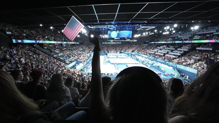 Fans cheer on athleties during the second session during a men's artistic gymnastics qualification round at the 2024 Summer Olympics, Saturday, July 27, 2024, in Paris, France. (AP Photo/Charlie Riedel)