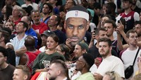 Para penggemar Amerika Serikat bersorak, saat salah satu dari mereka memegang potongan gambar LeBron James, sebelum pertandingan basket putra antara Amerika Serikat dan Sudan Selatan dimulai di Olimpiade Musim Panas 2024. AP/Mark J. Terrill