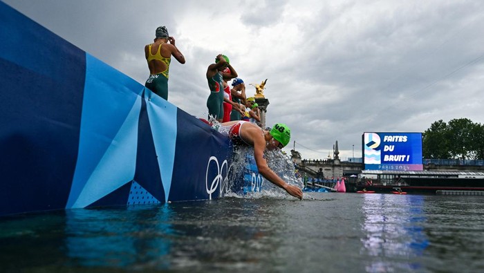 Paris 2024 Olympics - Triathlon - Womens Individual - Alexander III Bridge, Paris, France - July 31, 2024. Zsanett Kuttor-Bragmayer of Hungary splashes water on her face from the river Seine before the start of the race. Martin Bureau/Pool via REUTERS