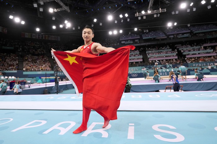 Zou Jingyuan, of China, celebrates after winning the gold medal during the mens artistic gymnastics individual parallel bars finals at Bercy Arena at the 2024 Summer Olympics, Monday, Aug. 5, 2024, in Paris, France. (AP Photo/Abbie Parr)