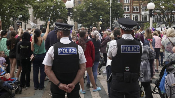 Tributes are seen outside the Town Hall during a vigil to remember the victims of the stabbing attack last Monday in Southport, England, Monday, Aug. 5, 2024. Violence and unrest erupted in cities and towns across Britain, ostensibly in protest of last week's stabbing. (AP Photo/Darren Staples)