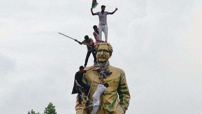 Demonstran Rusak Patung Pendiri Bangsa di Bangladesh People vandalise the statue of Sheikh Mujibur Rahman at Bijoy Sarani area, the 'Father of the Nation', as they celebrate the resignation of the Prime Minister Sheikh Hasina in Dhaka, Bangladesh, August 5, 2024. REUTERS/Mohammad Ponir Hossain