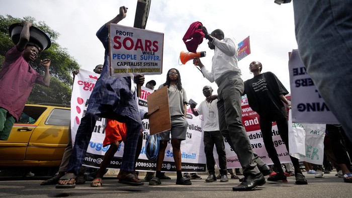 A woman with her baby joins a protest over economic hardship on a street in Lagos, Nigeria, Monday, Aug 5, 2024.  (AP Photo/Sunday Alamba)