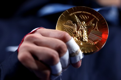 PARIS, FRANCE - JULY 31: A detailed view of the gold medal held by Lasha Bekhauri of Team Georgia during the medal on the podium during the Men -90 kg medal ceremony on day five of the Olympic Games Paris 2024 at Champs-de-Mars Arena on July 31, 2024 in Paris, France. (Photo by Steph Chambers/Getty Images)