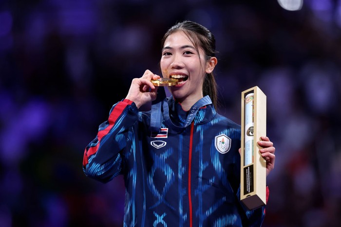 PARIS, FRANCE - AUGUST 07: Gold medalist Panipak Wongpattanakit of Team Thailand celebrates on the podium during the Womens Taekwondo -49kg Medal Ceremony on day twelve of the Olympic Games Paris 2024 at Grand Palais on August 07, 2024 in Paris, France. (Photo by Alex Pantling/Getty Images)