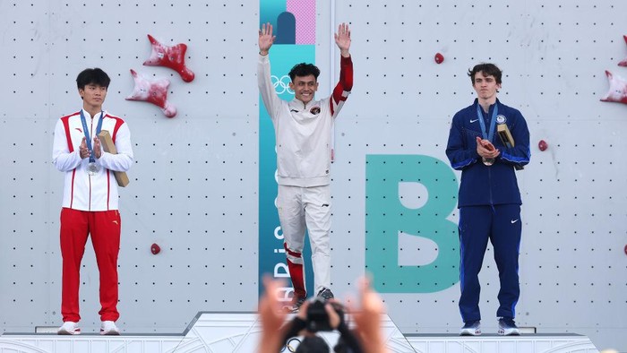 PARIS, FRANCE - AUGUST 08: Gold medalist Veddriq Leonardo of Team Indonesia (C), Silver medalist Wu Peng of Team People’s Republic of China (L) and Bronze medalist Sam Watson of Team United States (R) celebrate on the podium during the Sport Climbing medal ceremony after the Mens Speed on Day thirteen of the Olympic Games Paris 2024 at Le Bourget Sport Climbing Venue on August 08, 2024 in Paris, France. (Photo by Michael Reaves/Getty Images)