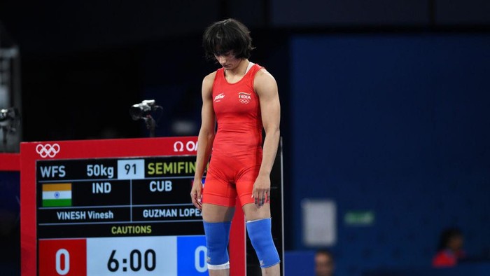 PARIS, FRANCE - AUGUST 06: Vinesh Vinesh of Team India (red) looks on as competes with Yusneylis Guzman Lopez of Team Cuba (not pictured) during the Wrestling Womens Freestyle 50kg Semifinal on day eleven of the Olympic Games Paris 2024 at Champs-de-Mars Arena on August 06, 2024 in Paris, France. (Photo by David Ramos/Getty Images)