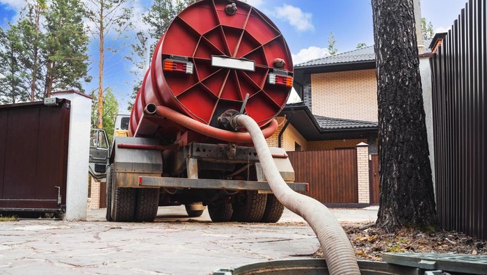 Sewage Tank truck. Sewer pumping machine. Septic truck. Pipe in the drainage pit. Pumping out sewage from a septic tank. Septic tank service