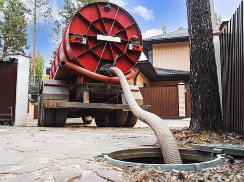 Sewage Tank truck. Sewer pumping machine. Septic truck. Pipe in the drainage pit. Pumping out sewage from a septic tank. Septic tank service