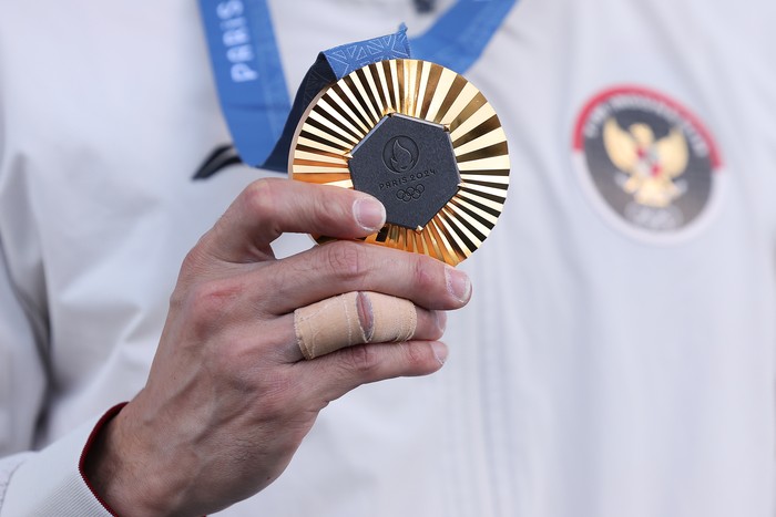 PARIS, FRANCE - AUGUST 08: A detailed view of Veddriq Leonardo of Team Indonesias Gold medal on the podium during the Sport Climbing medal ceremony after the Mens Speed Big Final on Day thirteen of the Olympic Games Paris 2024 at Le Bourget Sport Climbing Venue on August 08, 2024 in Paris, France. (Photo by Luke Hales/Getty Images)