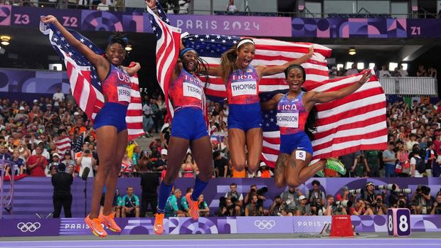 Paris 2024 Olympics - Athletics - Women's 4 x 100m Relay Final - Stade de France, Saint-Denis, France - August 09, 2024. Gold medallist's Melissa Jefferson of United States, Twanisha Terry of United States, Gabrielle Thomas of United States and Sha'Carri Richardson of United States celebrate with their national flags. REUTERS/Aleksandra Szmigiel     TPX IMAGES OF THE DAY